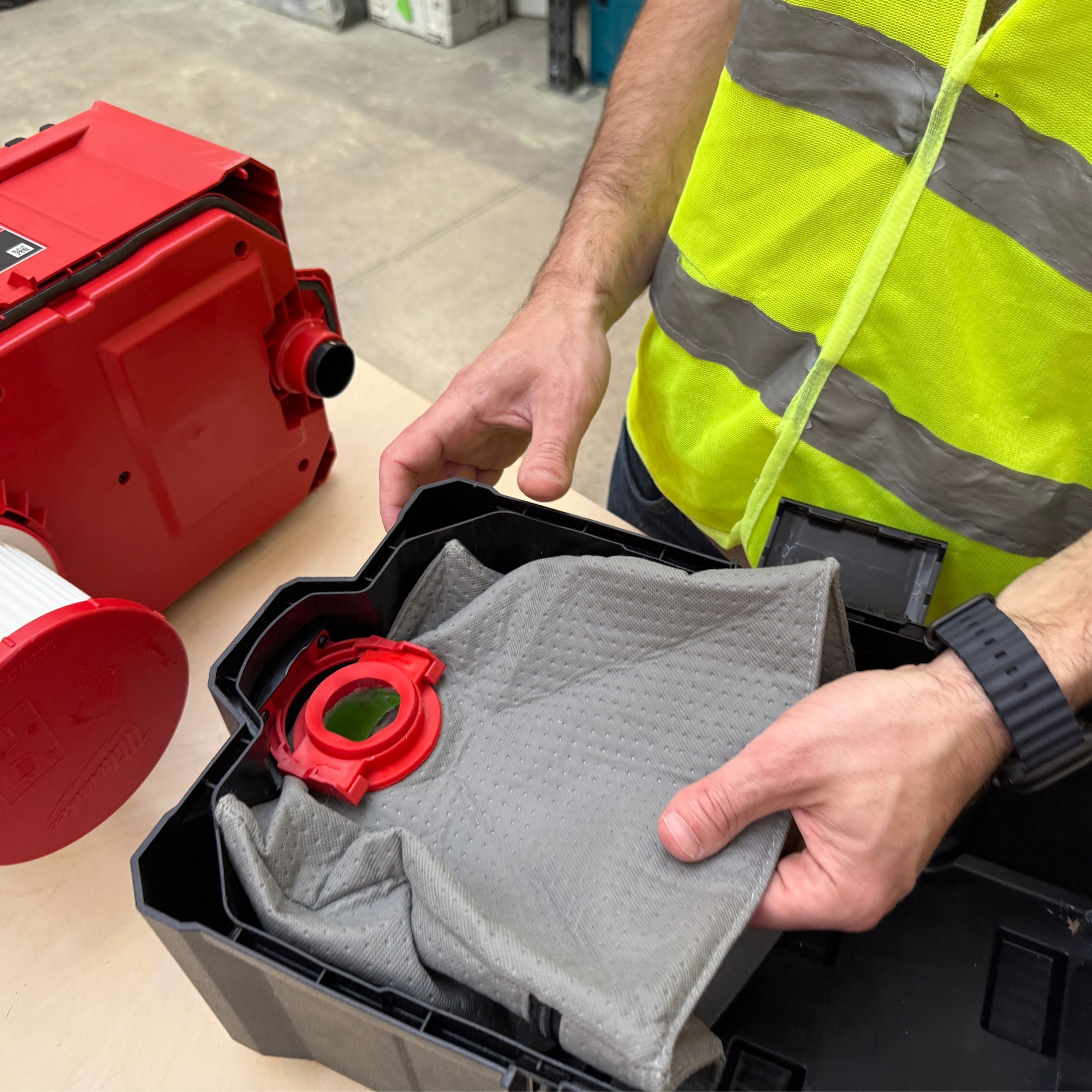 Reusable dust bag for Milwaukee M18 Fuel Packout shown with vacuum accessories